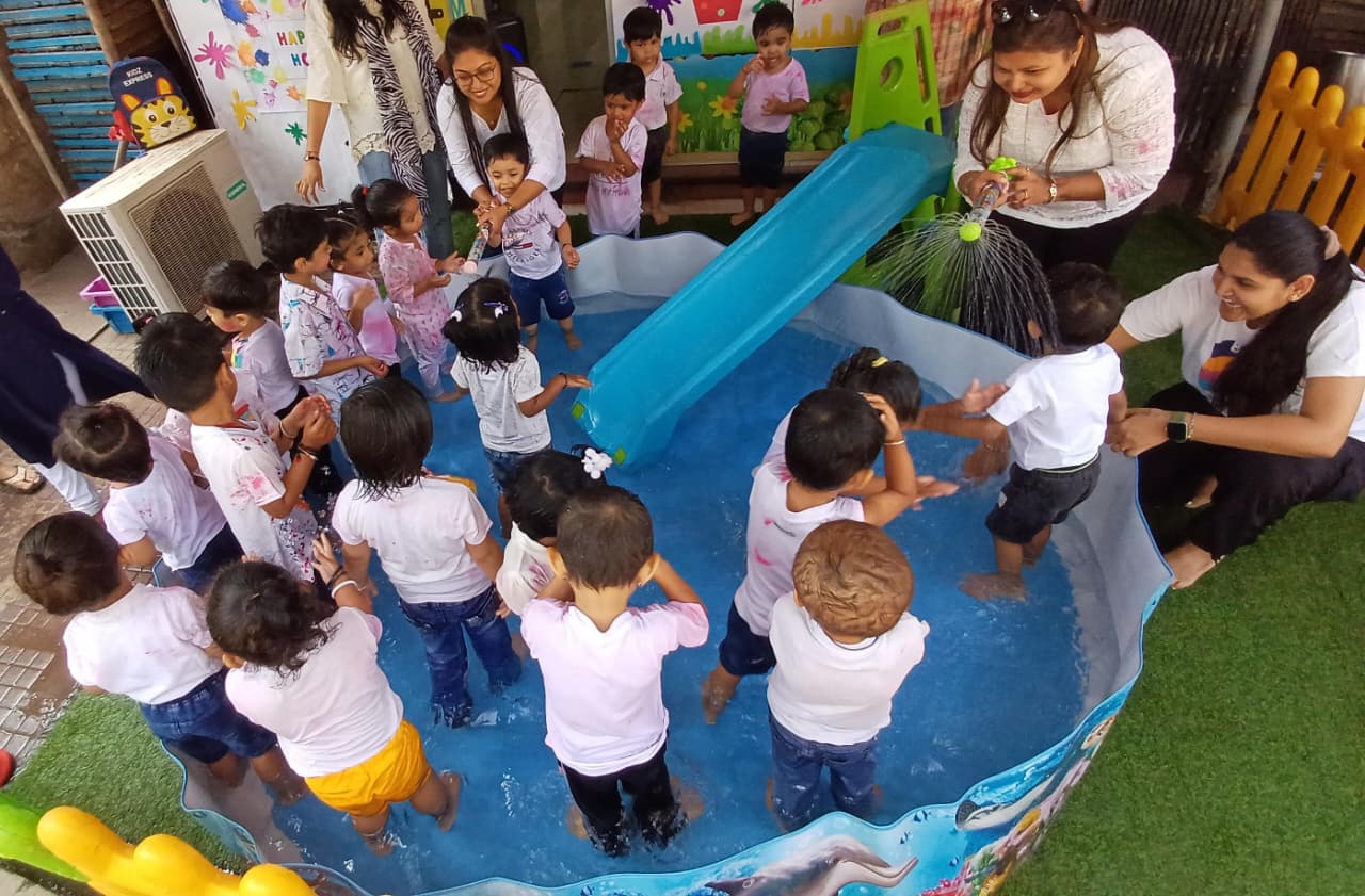 Preschoolers enjoying water play in a paddling pool